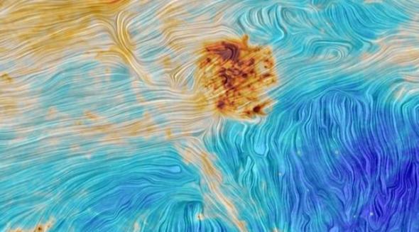 图中蓝色色调的区域暗示这里有着非常低密度的宇宙尘埃。令人耳晕目眩的漩涡状结构其实是望远镜上的仪器噪声引发的