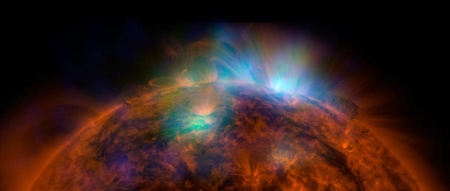 NuSTAR拍摄的图片覆盖在SDO拍摄的照片上面，X射线正逃离太阳。NuSTAR的数据是绿色和蓝色部分，揭示了太阳的高能辐射（绿色区域能量在2-3千电子伏特，蓝