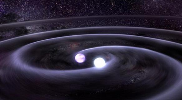 艺术概念图，展示了两颗中子星。对于神秘的快速无线电爆发，科学家给出了各种解释，其中包括外星人和中子星相撞。通常情况下，两颗中子星相撞会形成一个黑洞以及一个强度达