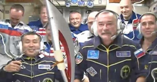 俄罗斯宇航员米哈伊尔・秋林在远征37-38任务中手持奥运火炬的情景。