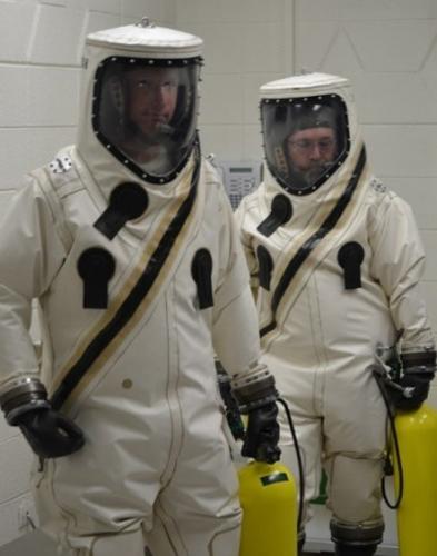 车间中全副“武装”的轨道科学公司技术人员，他们穿着的是“救生单元”