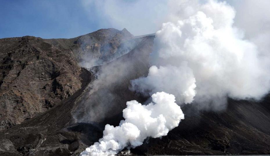 火山爆发流下来的岩溶流到西西里岛的海水中，同时伴随着滚滚的浓烟。
