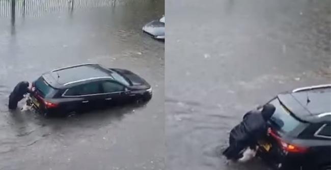 英国苏格兰女子发现有司机受困大水中立即上前帮忙推车 身旁的狗狗见状也加入